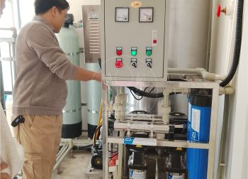 Công nhân đang kiểm tra đèn khử trùng UV và máy Ozone của hệ thống lọc nước RO công suất 1400 lit/h tại trường Marie Curie Long Biên.